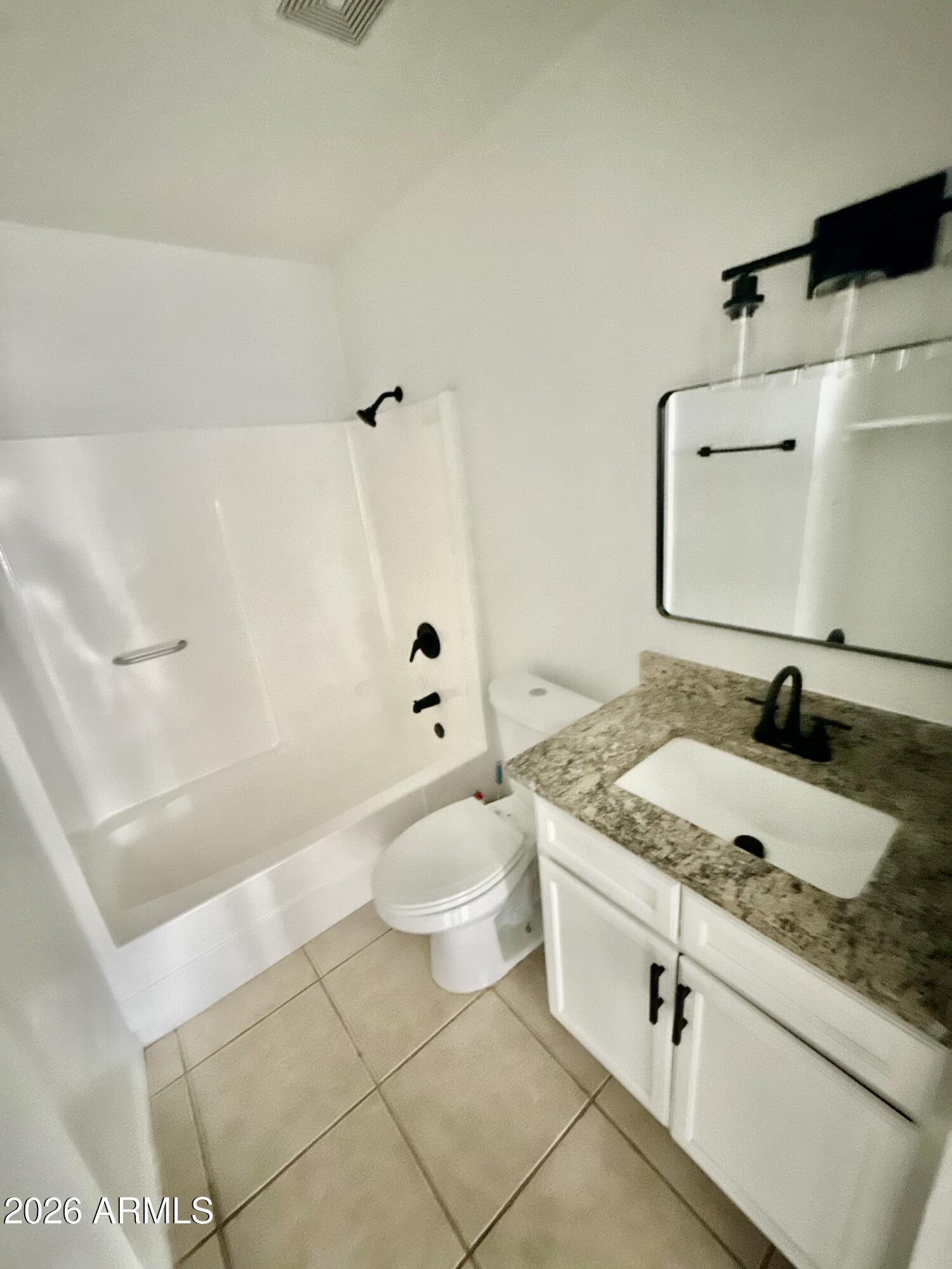 6963 West Rancho Drive Glendale, AZ 85303 - Photo 10 of 14 a bathroom with a granite countertop sink toilet and shower