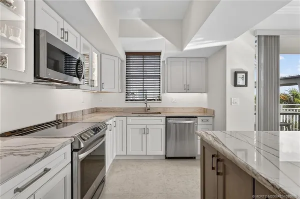 a bathroom with a granite countertop toilet sink and mirror