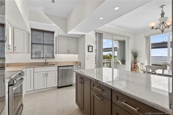 a bathroom with a granite countertop toilet a sink and a mirror