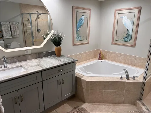 a view of a patio with a table and chairs and potted plants