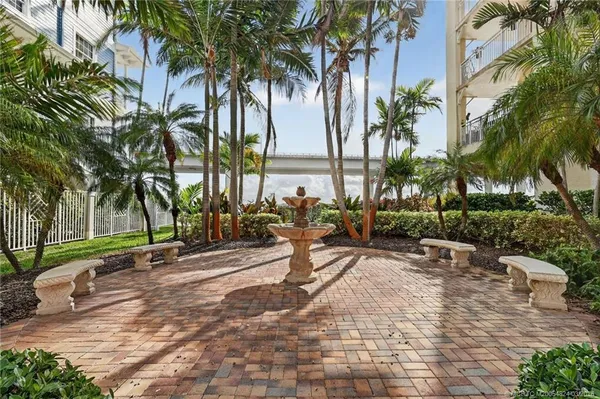 a view of a house with pool and sitting area