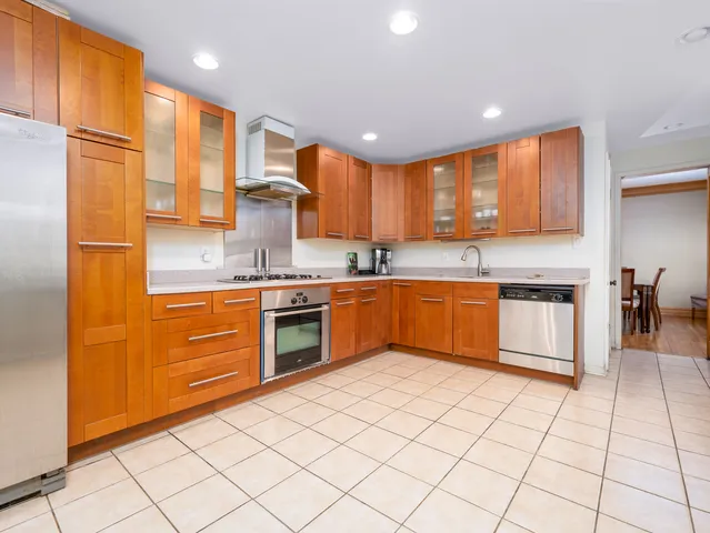 a kitchen with stainless steel appliances granite countertop a refrigerator sink and cabinets