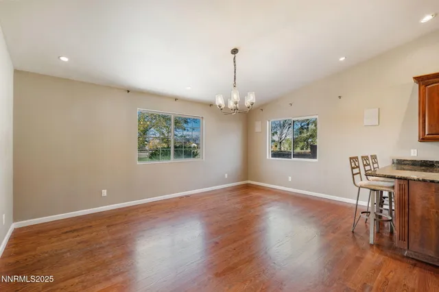 a view of a livingroom with furniture wooden floor a chandelier