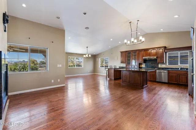 a view of a kitchen with a sink and wooden floor