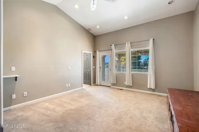 a view of an empty room with glass door