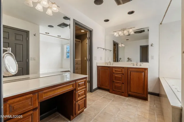 a spacious bathroom with a sink and a mirror