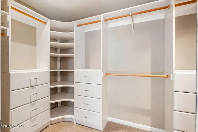 a view of walk in closet with empty racks