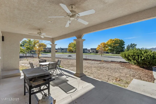 a view of a patio with a table and chairs