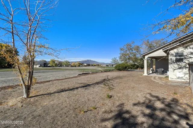 a view of a dirt road and a building
