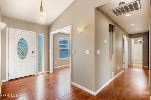 a view of hallway with wooden floor