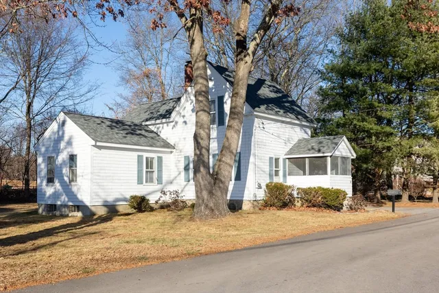 a front view of a house with a yard covered in snow