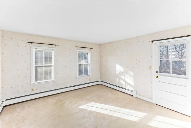 an empty room with a empty space and windows