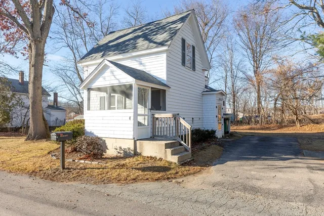 a front view of a house with a yard covered in snow