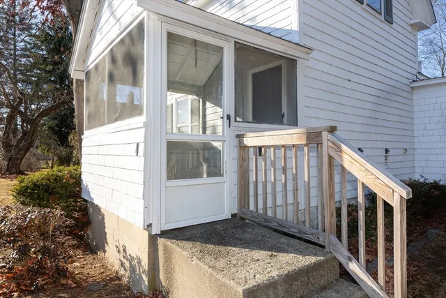 a view of front door and small yard