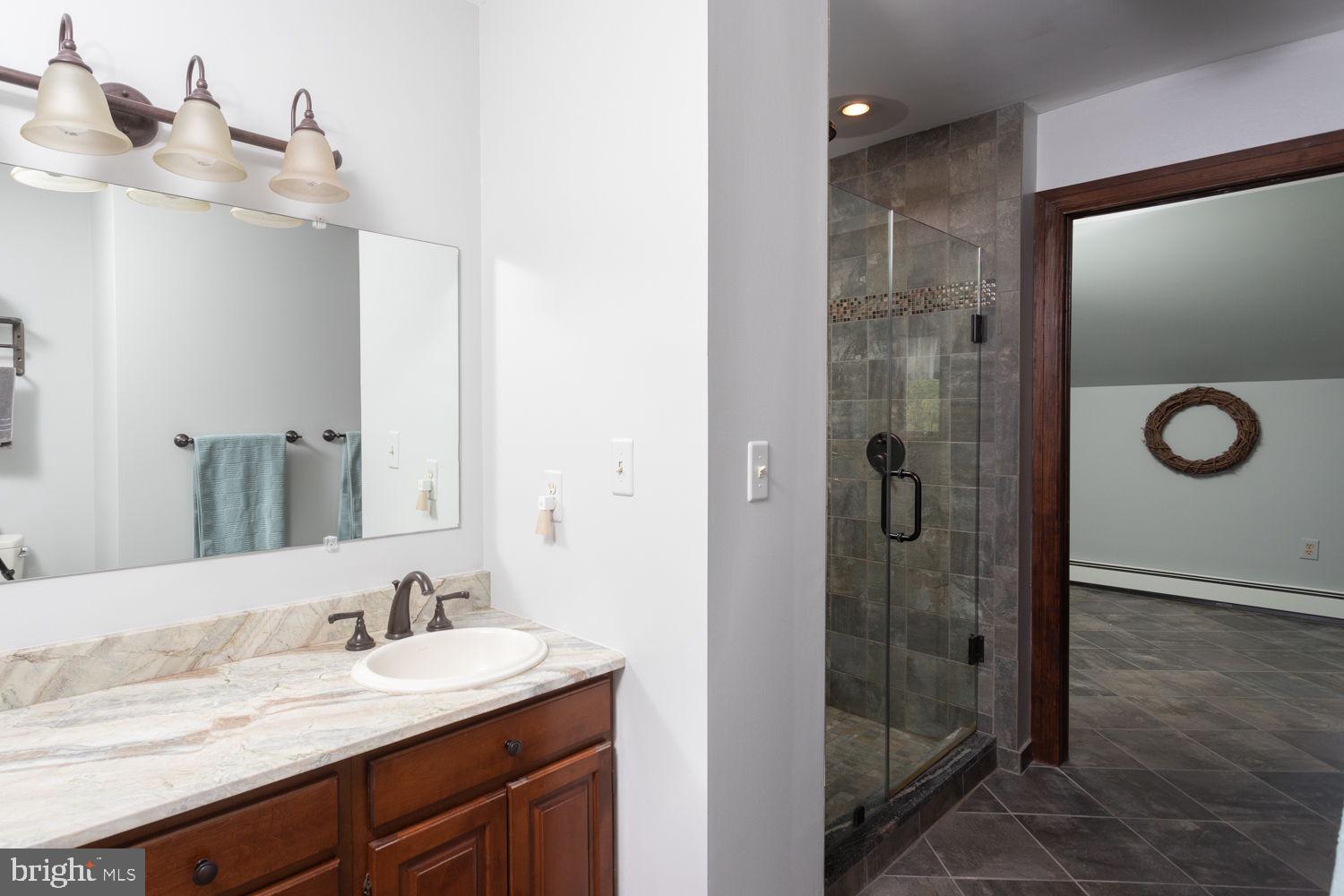 48 Harker Road Chesterfield, NJ 08515 - Photo 15 of 30 a bathroom with a granite countertop sink a mirror and shower