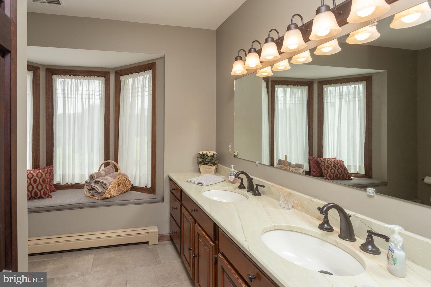 48 Harker Road Chesterfield, NJ 08515 - Photo 17 of 30 a bathroom with a double vanity sink and a mirror