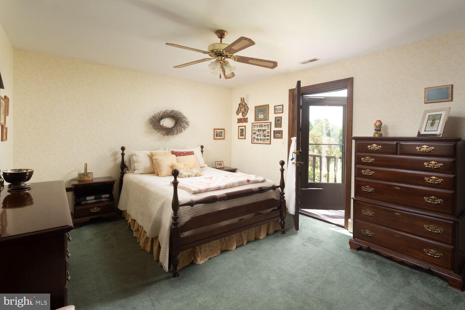 48 Harker Road Chesterfield, NJ 08515 - Photo 18 of 30 a bedroom with a bed and a chandelier