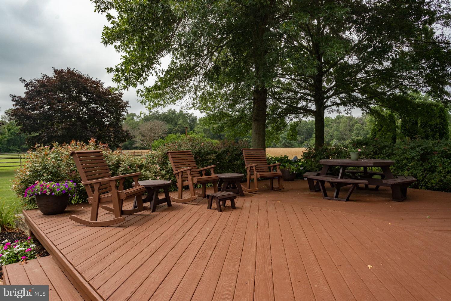 48 Harker Road Chesterfield, NJ 08515 - Photo 20 of 30 a view of a roof deck with table and chairs a barbeque with wooden floor and fence