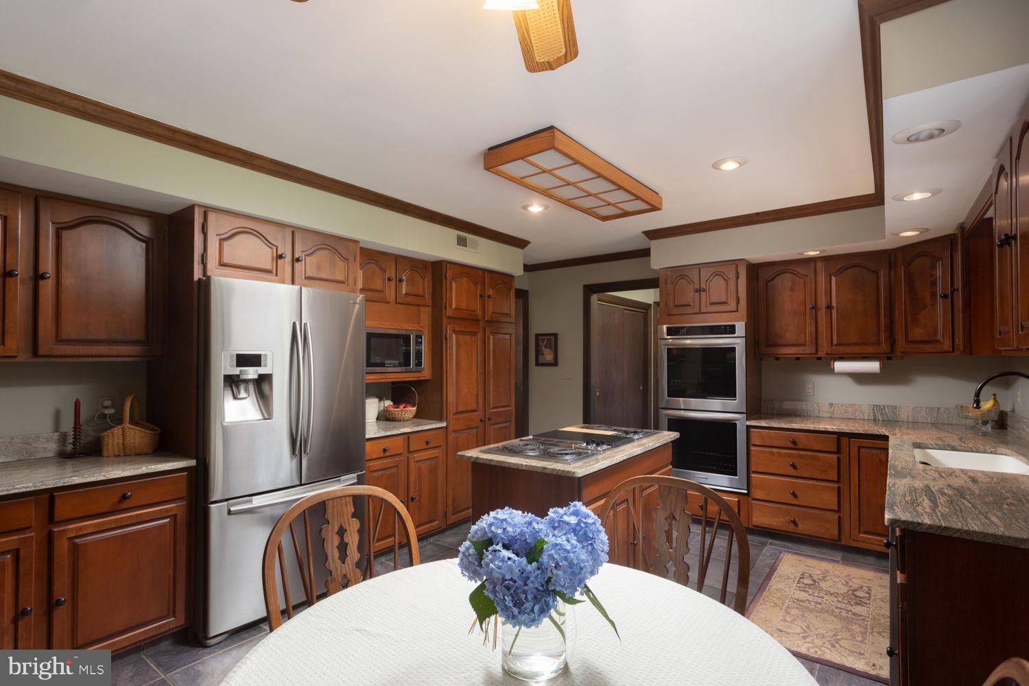 48 Harker Road Chesterfield, NJ 08515 - Photo 8 of 30 a kitchen with stainless steel appliances granite countertop a refrigerator a stove top oven a sink island and chairs