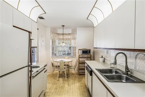 a kitchen with a sink appliances and cabinets