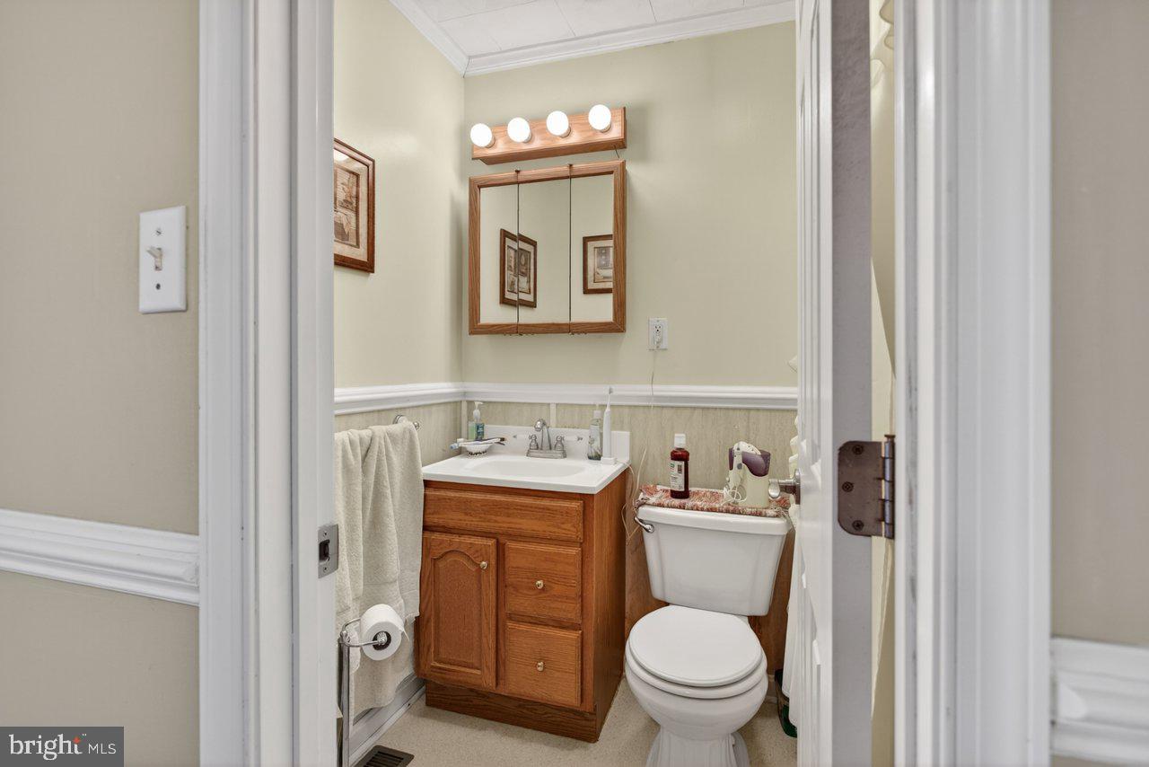 1751 Orchard Road Mount Jackson, VA 22842 - Photo 15 of 30 a bathroom with a toilet a sink and a mirror