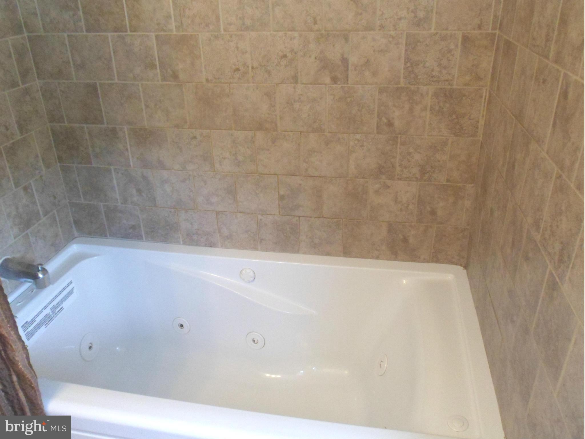 6110 Marlora Road Baltimore, MD 21239 - Photo 13 of 22 a view of a bathtub in a bathroom