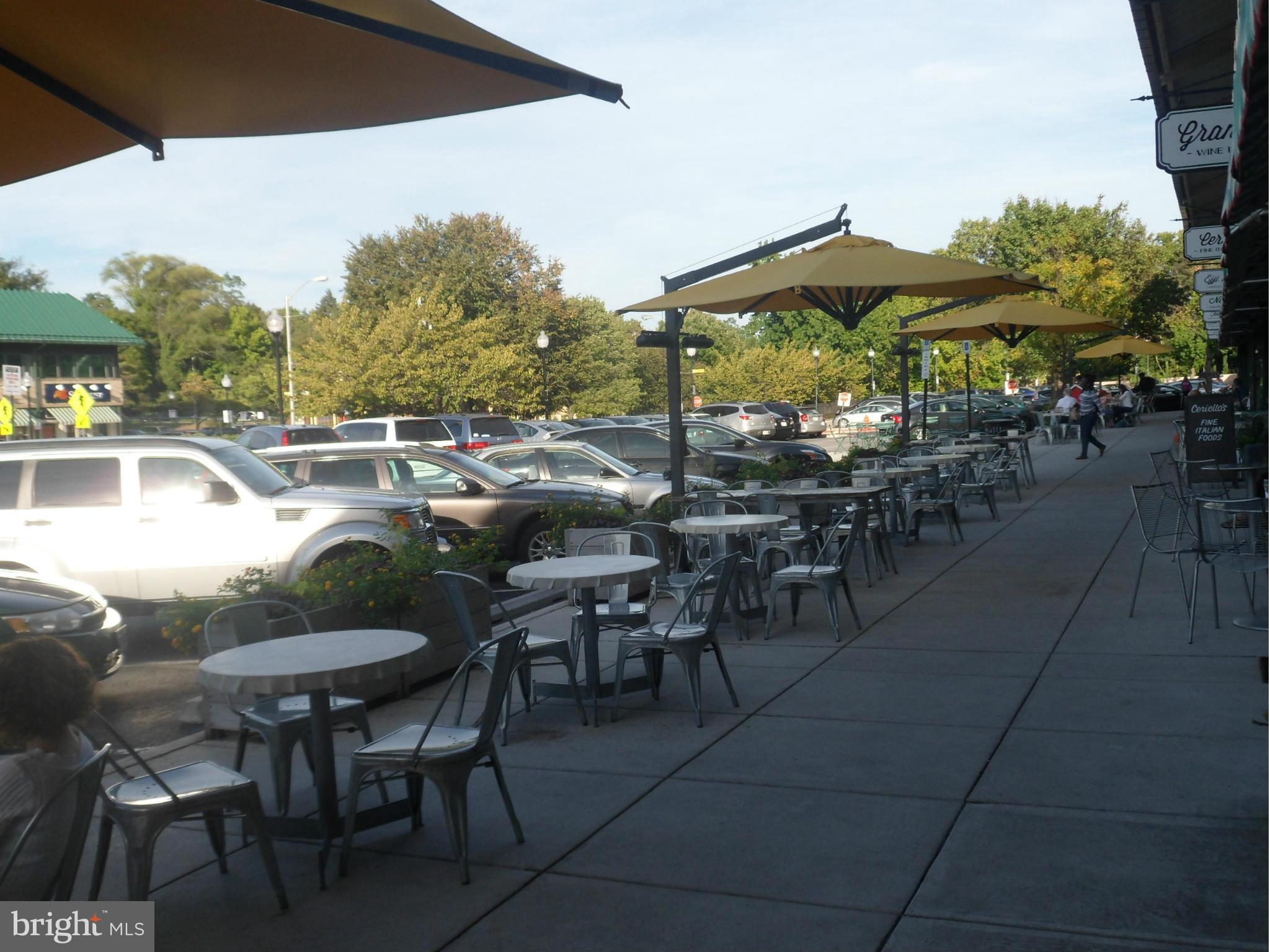 6110 Marlora Road Baltimore, MD 21239 - Photo 21 of 22 a view of a patio with dining table and chairs under an umbrella