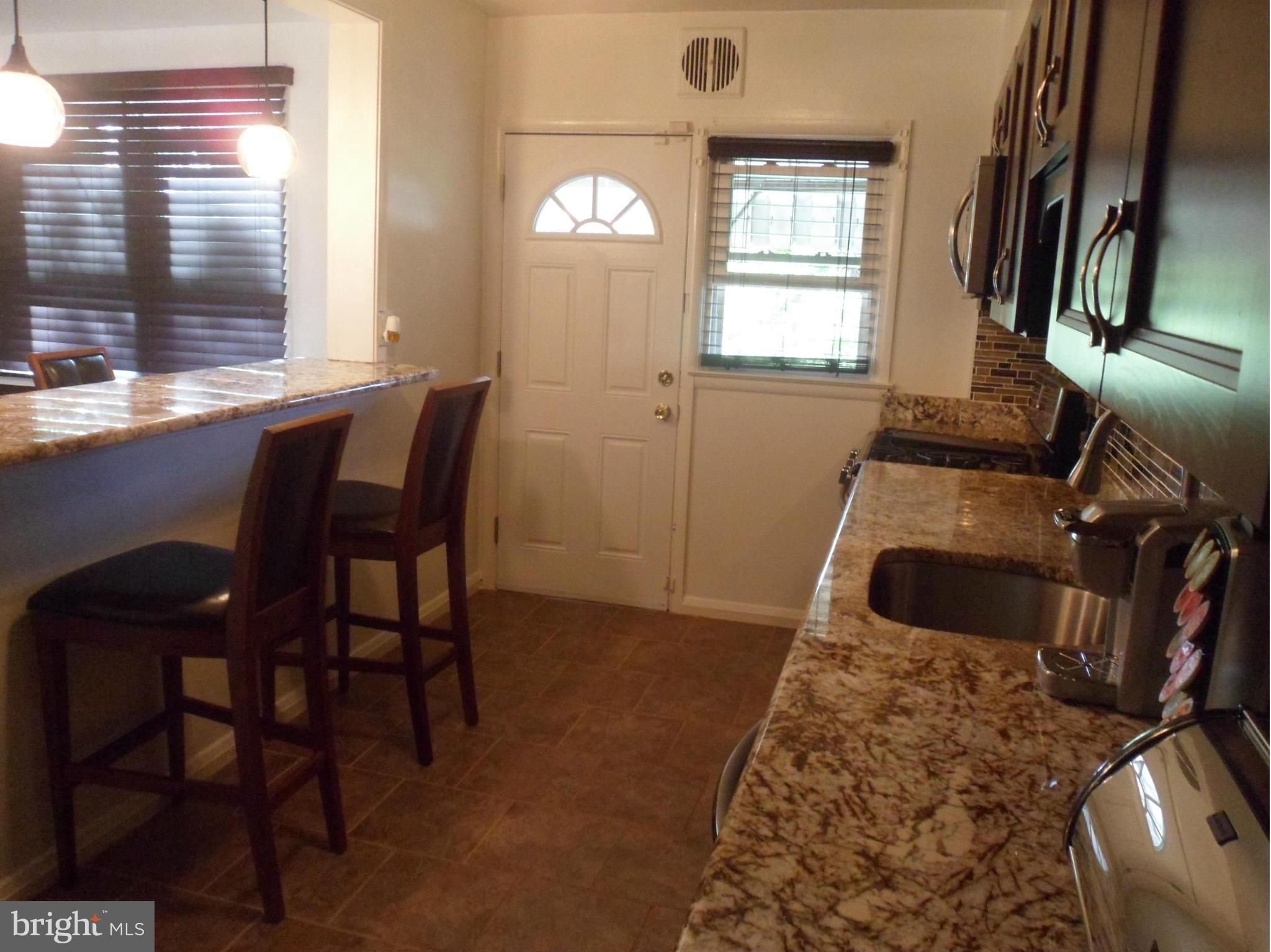 6110 Marlora Road Baltimore, MD 21239 - Photo 6 of 22 a view of a workspace with furniture and a window