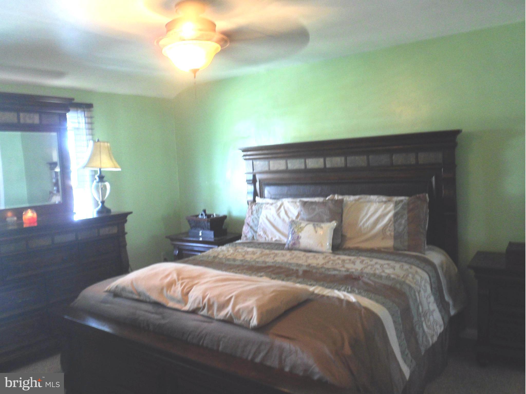 6110 Marlora Road Baltimore, MD 21239 - Photo 9 of 22 a bedroom with a bed and a chandelier