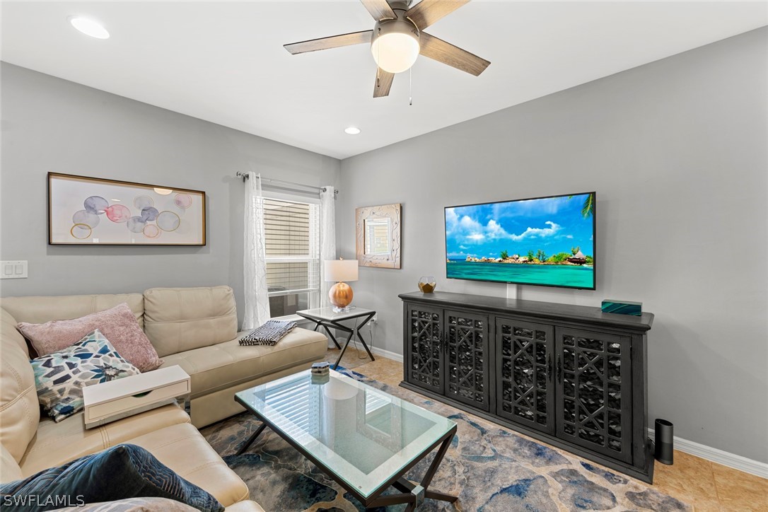 3849 Tilbor Circle Fort Myers, FL 33916 - Photo 11 of 28 a living room with furniture a rug and a flat screen tv