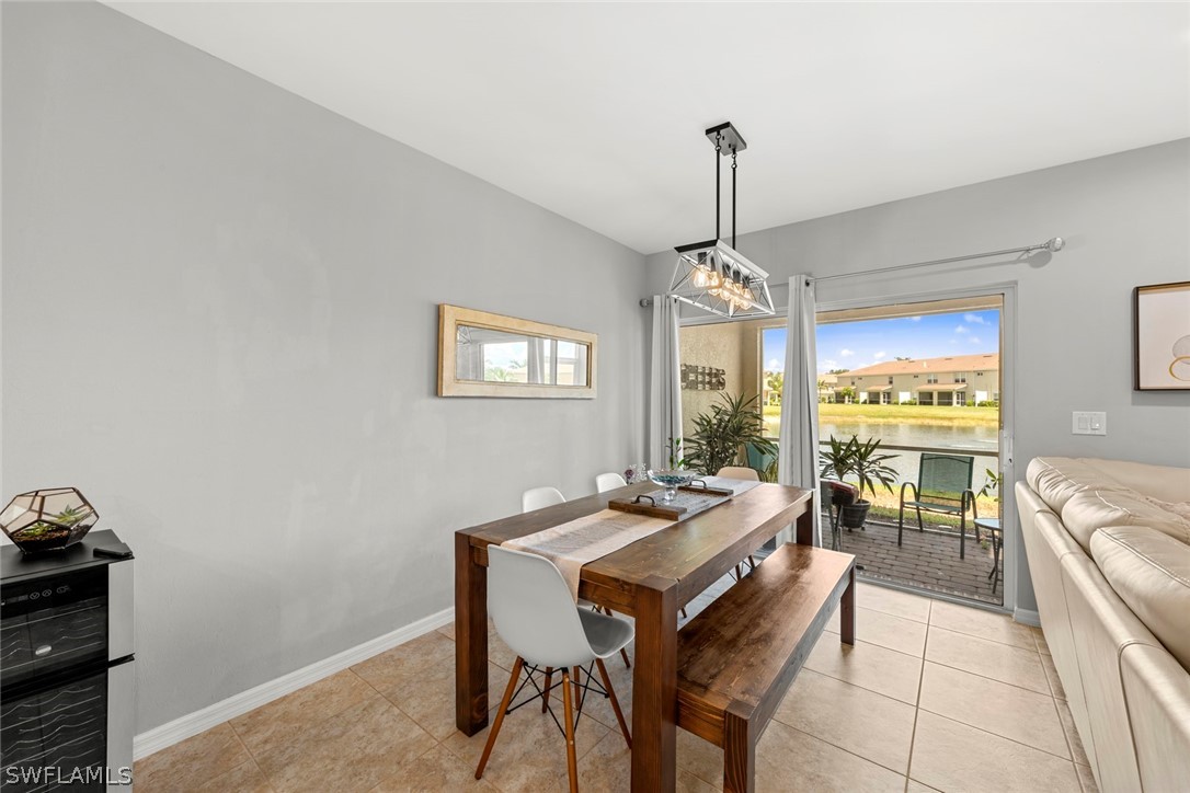 3849 Tilbor Circle Fort Myers, FL 33916 - Photo 13 of 28 a dining room with furniture a chandelier and window