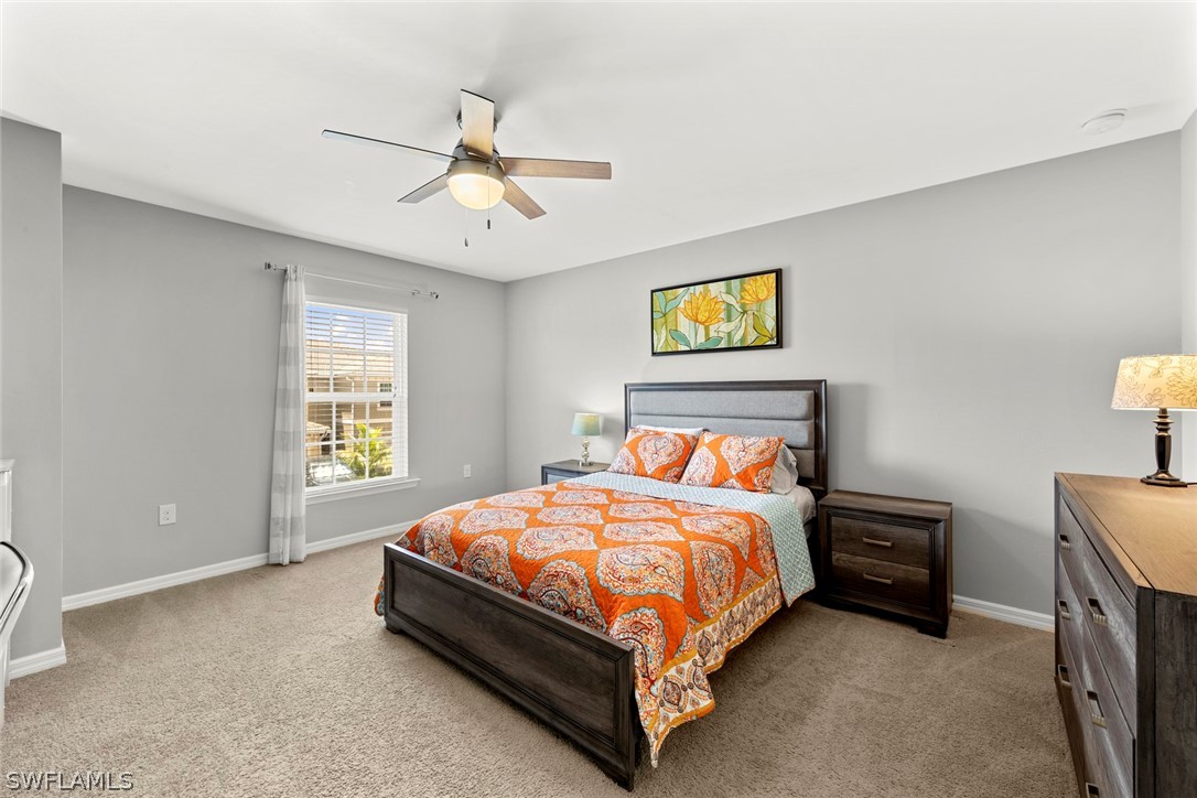 3849 Tilbor Circle Fort Myers, FL 33916 - Photo 16 of 28 a bedroom with a bed and a window