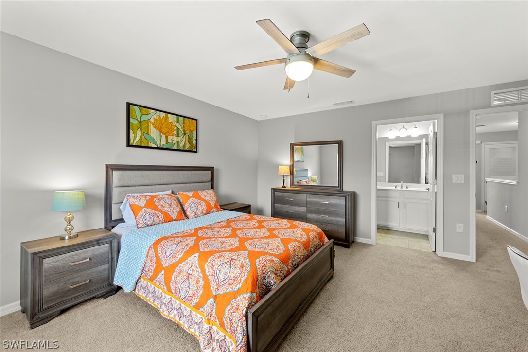3849 Tilbor Circle Fort Myers, FL 33916 - Photo 17 of 28 a bedroom with a bed and a chandelier