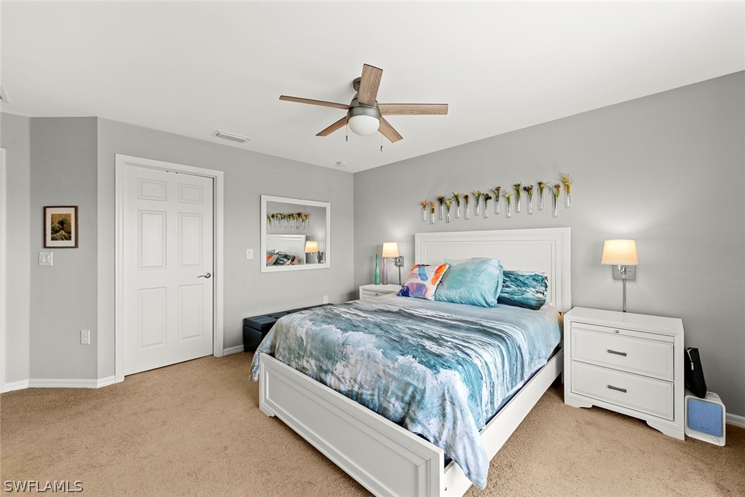 3849 Tilbor Circle Fort Myers, FL 33916 - Photo 21 of 28 a bedroom with a bed and a chandelier