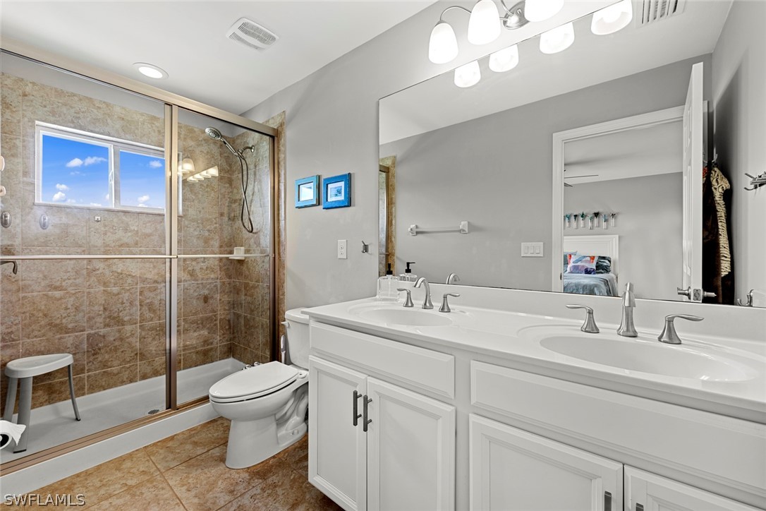 3849 Tilbor Circle Fort Myers, FL 33916 - Photo 22 of 28 a bathroom with a sink a toilet and shower
