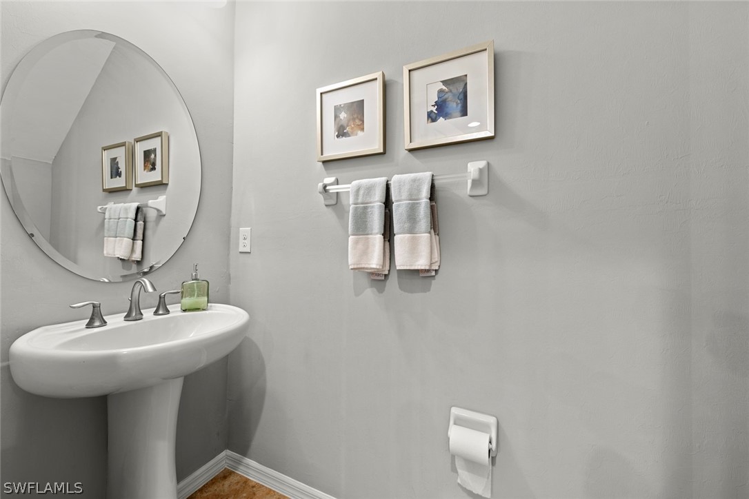 3849 Tilbor Circle Fort Myers, FL 33916 - Photo 23 of 28 a bathroom with a sink a mirror and vanity