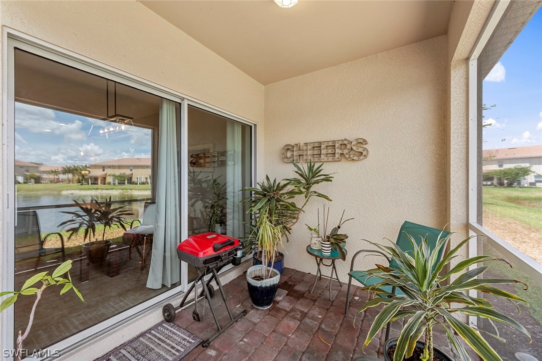 3849 Tilbor Circle Fort Myers, FL 33916 - Photo 26 of 28 a living room with furniture next to a large window with potted plants