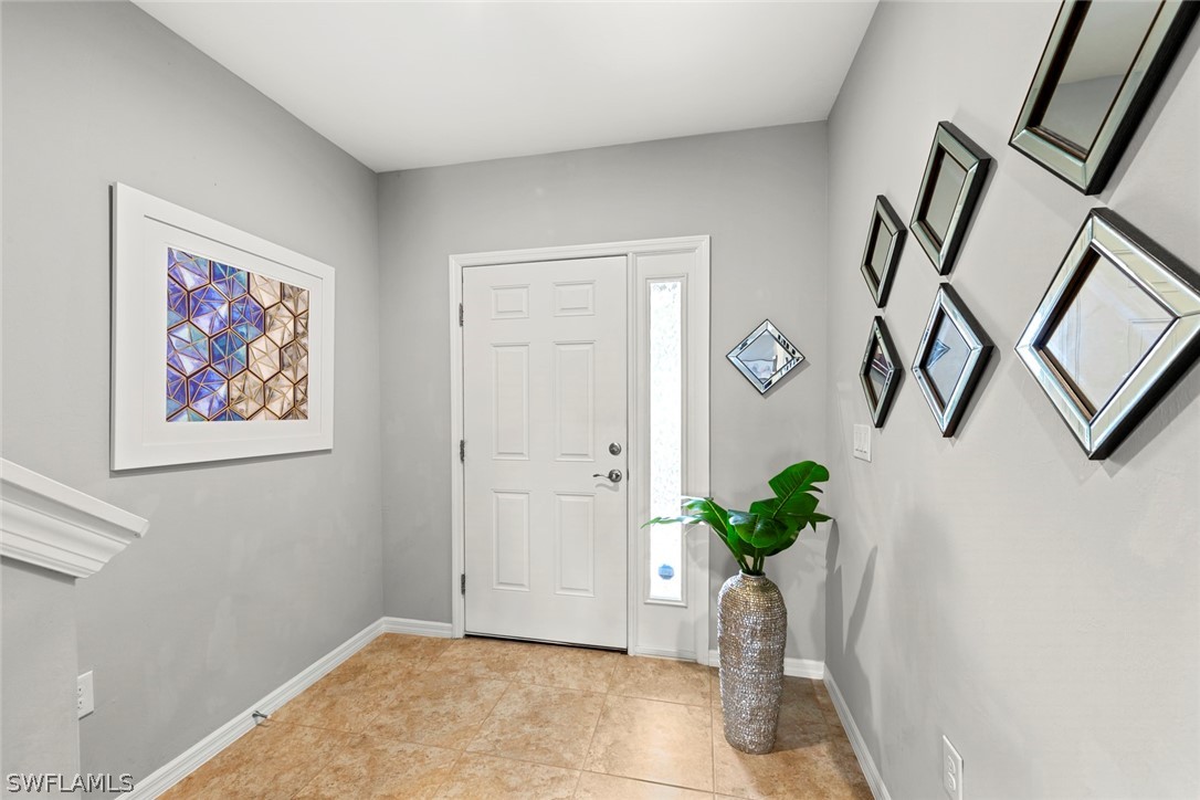 3849 Tilbor Circle Fort Myers, FL 33916 - Photo 3 of 28 a view of entryway with paintings on the wall