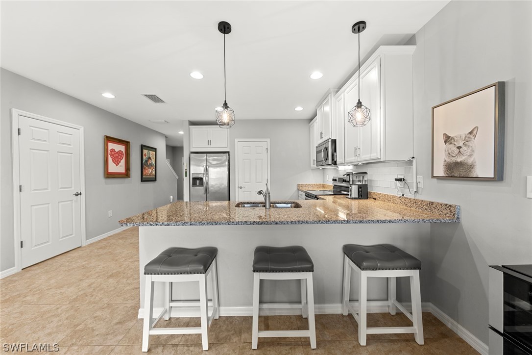 3849 Tilbor Circle Fort Myers, FL 33916 - Photo 6 of 28 a kitchen with cabinets and chairs