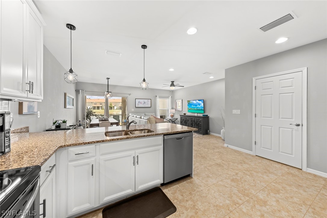 3849 Tilbor Circle Fort Myers, FL 33916 - Photo 7 of 28 a kitchen with stainless steel appliances granite countertop a sink and stove
