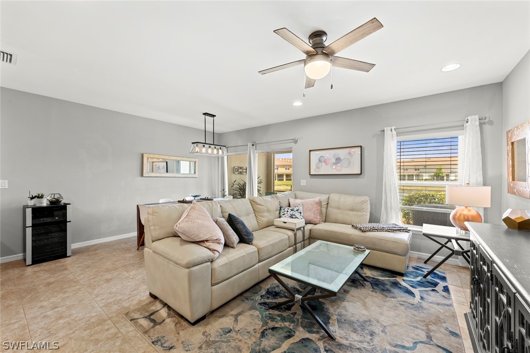 3849 Tilbor Circle Fort Myers, FL 33916 - Photo 8 of 28 a living room with furniture ceiling fan and a window