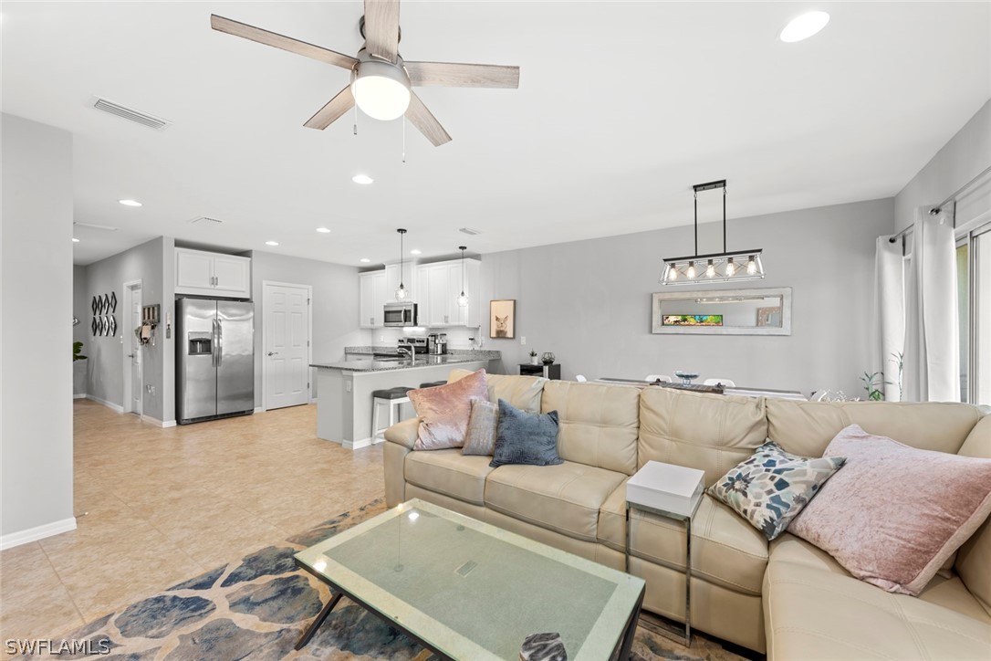 3849 Tilbor Circle Fort Myers, FL 33916 - Photo 9 of 28 a living room with furniture and kitchen view