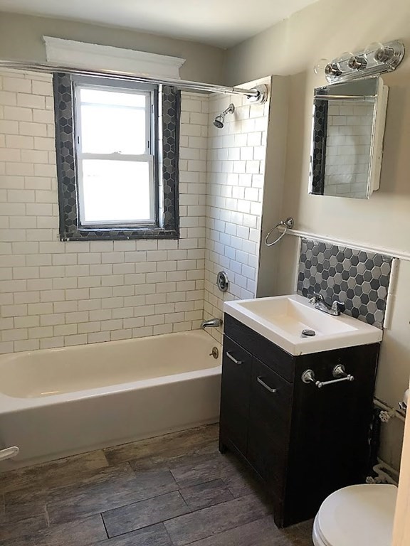 19 Arden Street, Unit 2 Boston, MA 02134 - Photo 5 of 8 a bathroom with a sink toilet vanity and bathtub