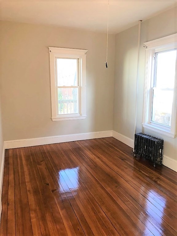19 Arden Street, Unit 2 Boston, MA 02134 - Photo 6 of 8 an empty room with wooden floor and windows