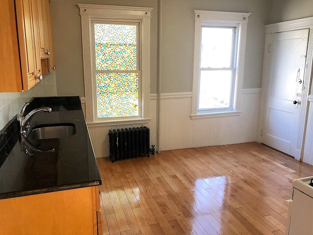 19 Arden Street, Unit 2 Boston, MA 02134 - Photo 7 of 8 a view of a bedroom with wooden floor and a window