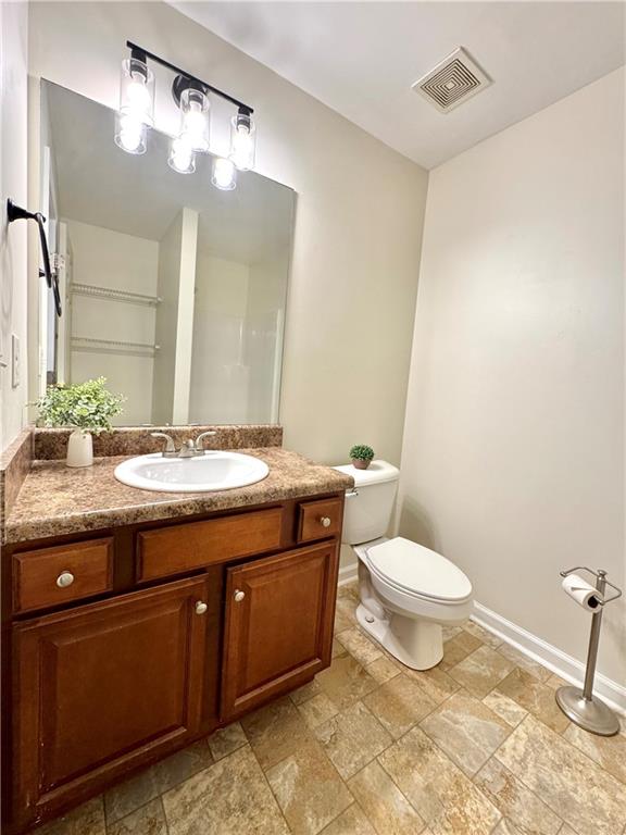 636 Hardy Way Hiram, GA 30141 - Photo 14 of 27 a bathroom with a granite countertop toilet sink and mirror