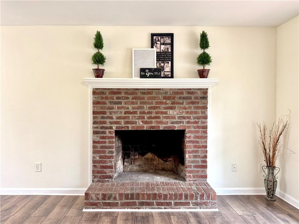 636 Hardy Way Hiram, GA 30141 - Photo 7 of 27 a living room with a fireplace and a potted plant