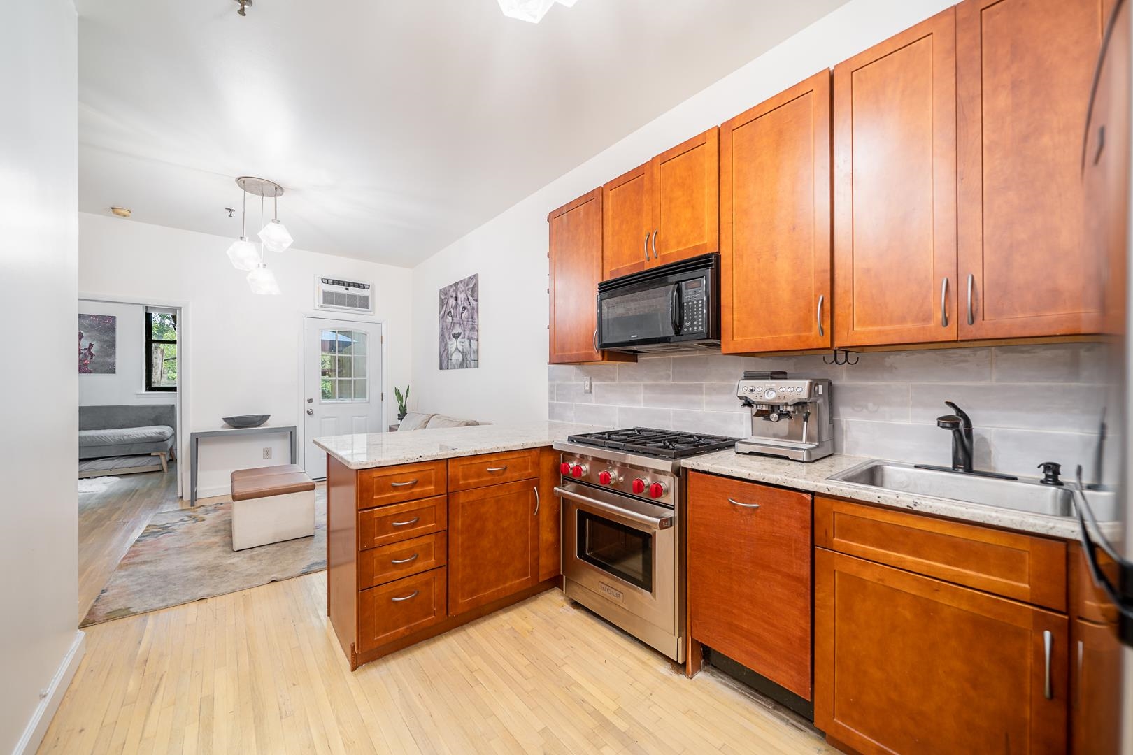 554 Observer Highway, Unit 1R Hoboken, NJ 07030 - Photo 1 of 21 a kitchen with stainless steel appliances granite countertop a sink stove and cabinets