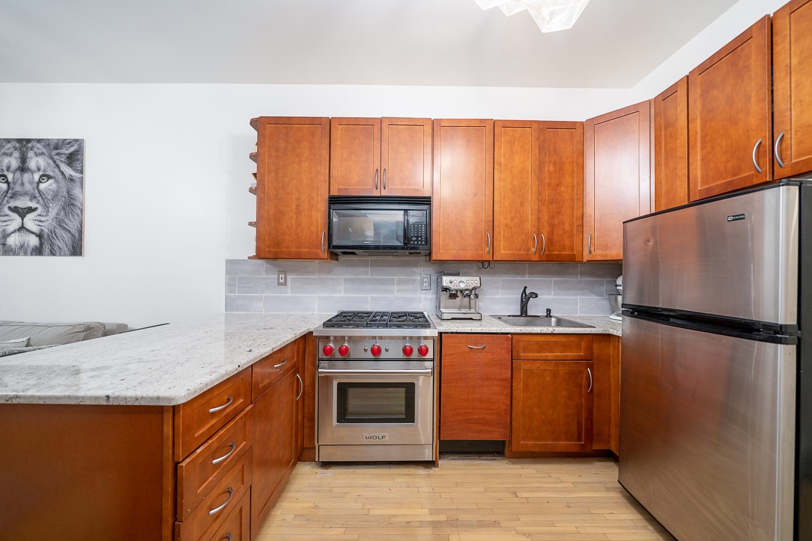 554 Observer Highway, Unit 1R Hoboken, NJ 07030 - Photo 2 of 21 a kitchen with stainless steel appliances granite countertop a stove a sink dishwasher and a refrigerator