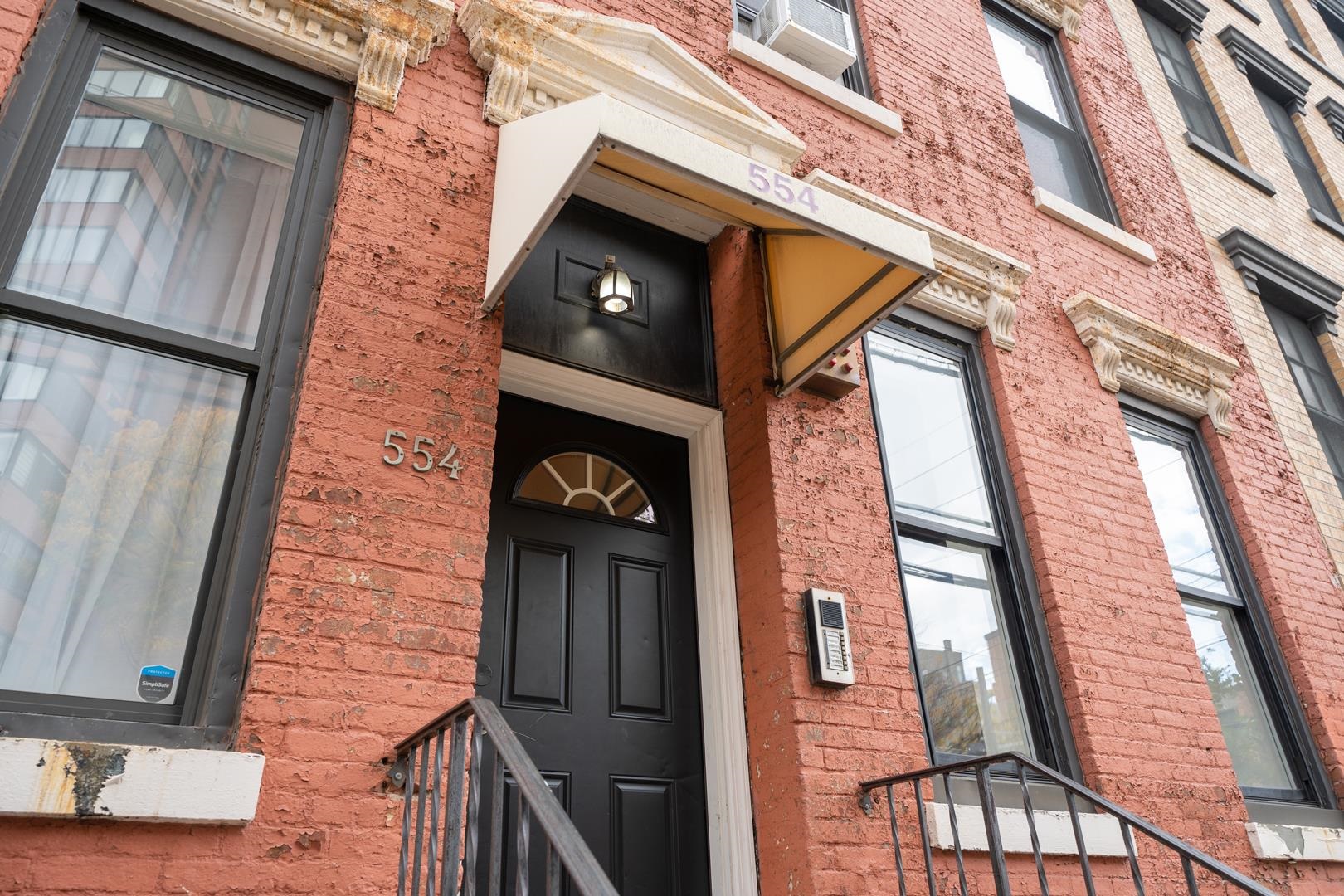 554 Observer Highway, Unit 1R Hoboken, NJ 07030 - Photo 20 of 21 a brick building with a small yard